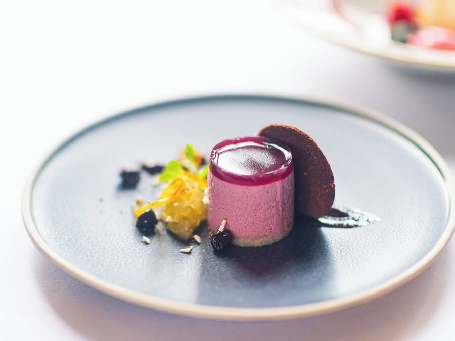 A dessert on a plate with a dark background.