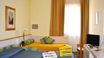 Cozy retreat with a comfortable bed, sofa, and desk area, perfect for working or relaxing.