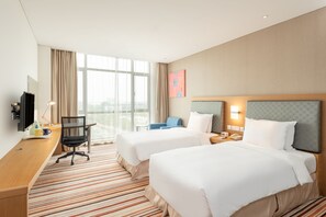 A hotel room with two beds, a desk, a chair, a TV, and a window with curtains. - Holiday Inn Express Shanghai Jiading Industry Park by IHG (Shanghai)