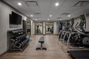 A gym with treadmills, stationary bikes, and weight machines. - Staybridge Suites Dearborn MI by IHG (Dearborn)