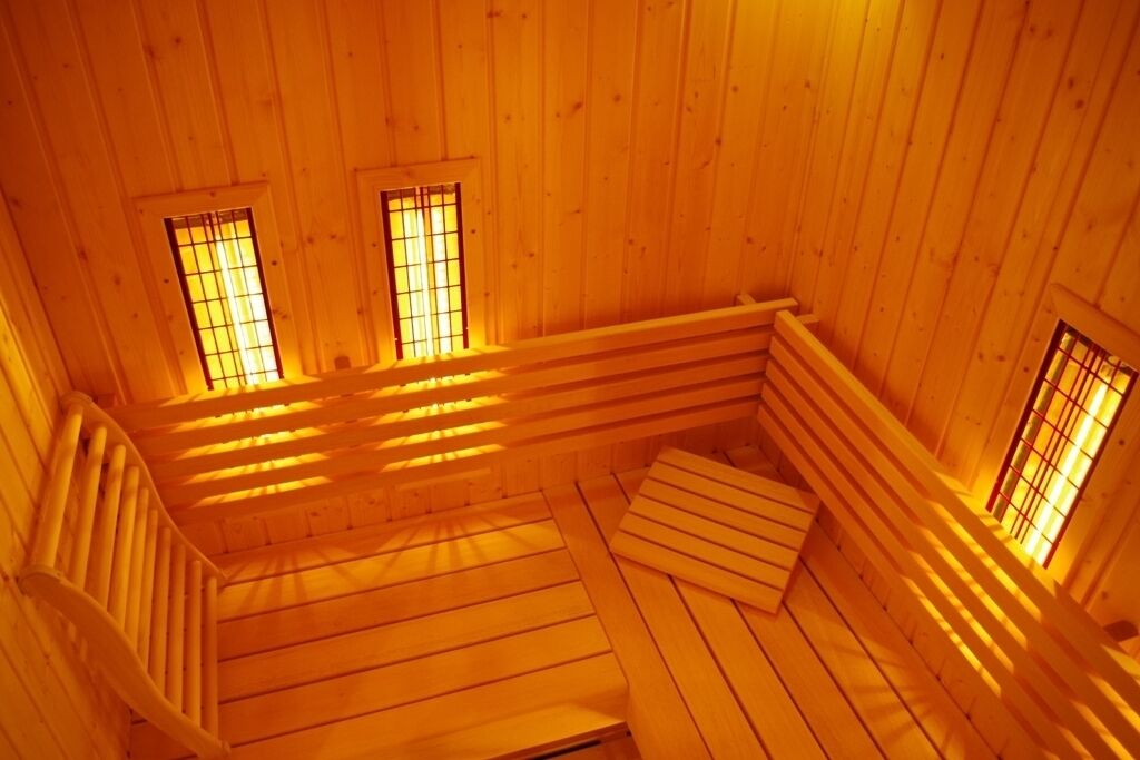 A wooden interior with a sloped ceiling and built-in benches.