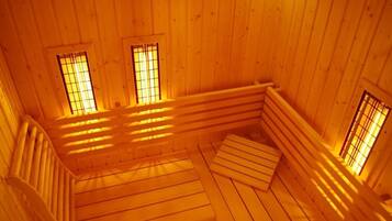 A wooden interior with a sloped ceiling and built-in benches.