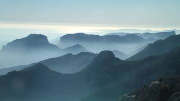 A mountainous landscape with layered hills and valleys.