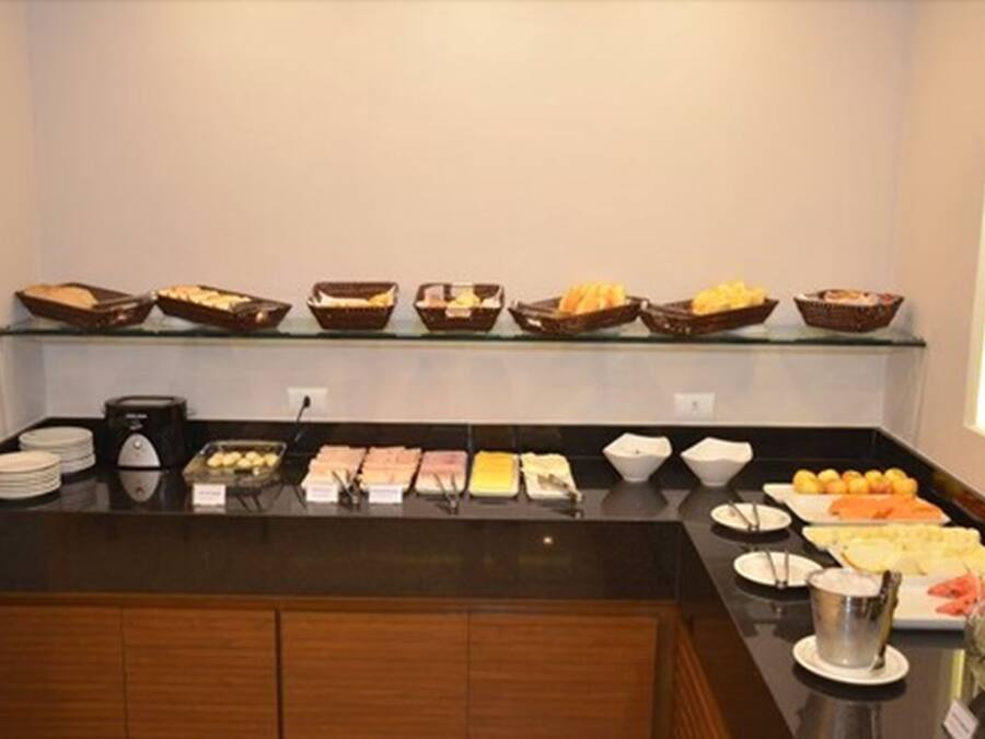 A buffet setup with various food items and utensils.