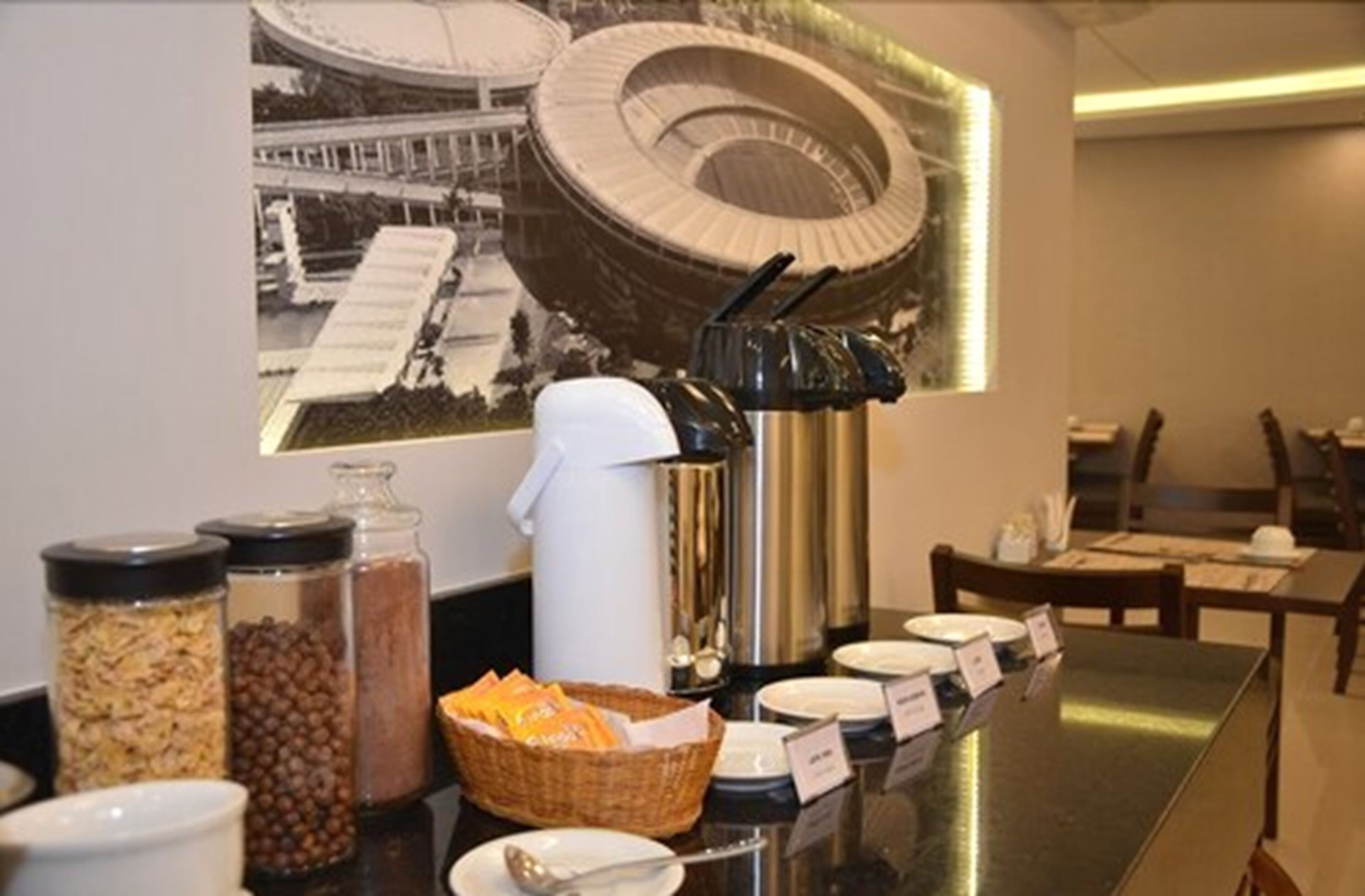 A breakfast buffet setup with various food items and a coffee machine.