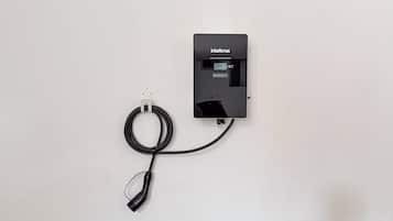 A wall-mounted power outlet with a cable connected to it.