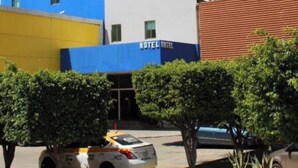 A multi-story hotel building with a blue and white facade, multiple windows, and a visible entrance. - Premier Inn Tuxtla (Tuxtla Gutierrez)