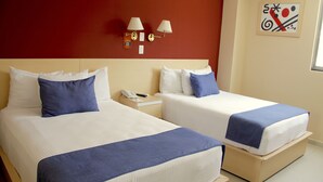 Two beds with white linens and blue accents, a nightstand with a phone, and wall-mounted lamps. - Premier Inn Tuxtla (Tuxtla Gutierrez)