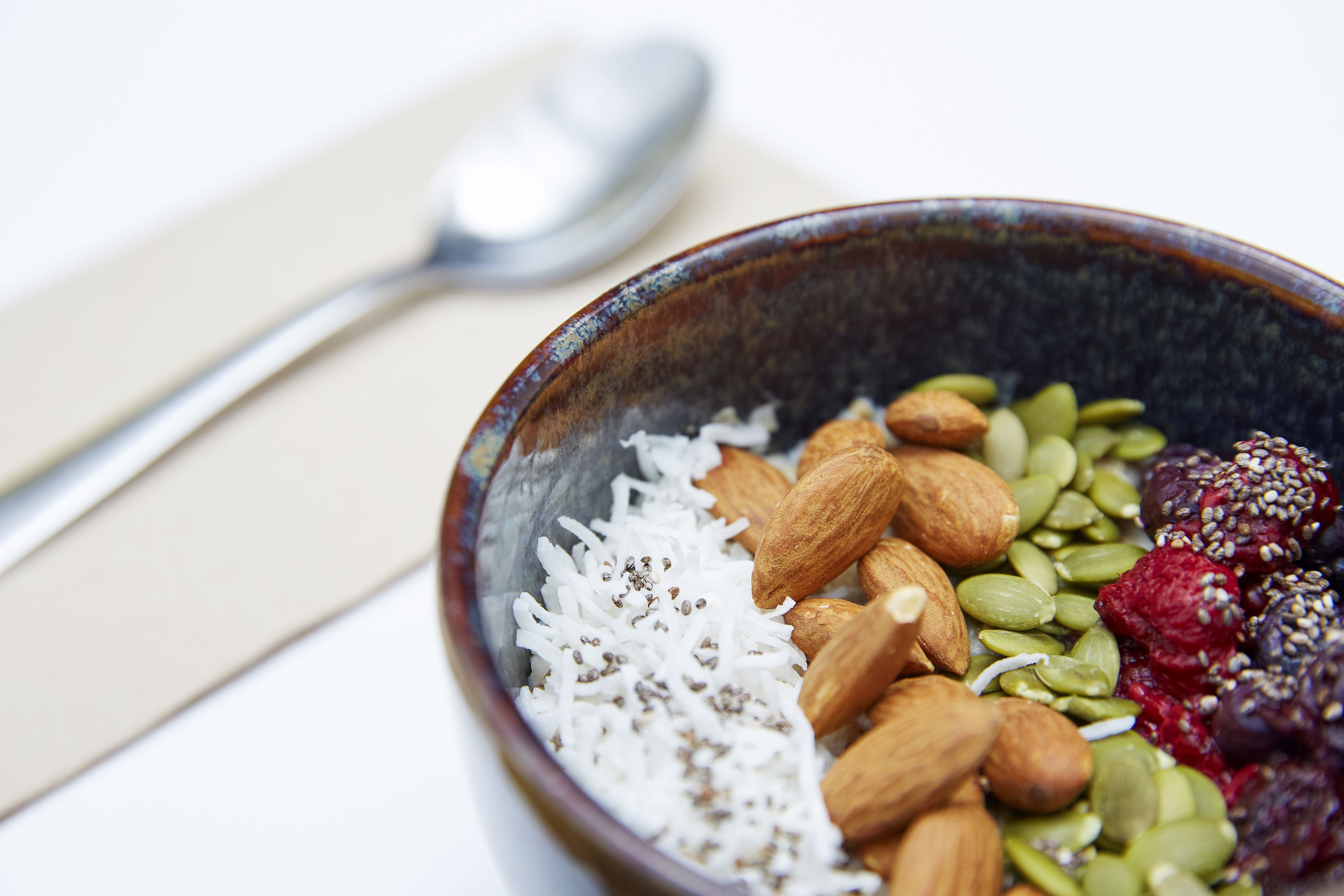 A bowl of assorted nuts and seeds.