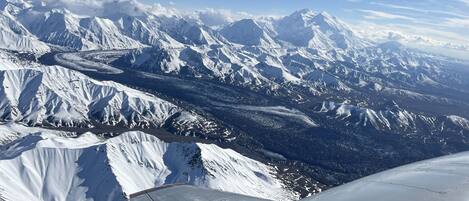 A snow-covered mountain range with a clear sky.