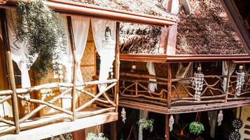Relax in a serene hot tub surrounded by a mosaic-tiled pool and lush greenery.