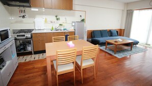 A compact living space with a kitchen, dining area, and a sofa.