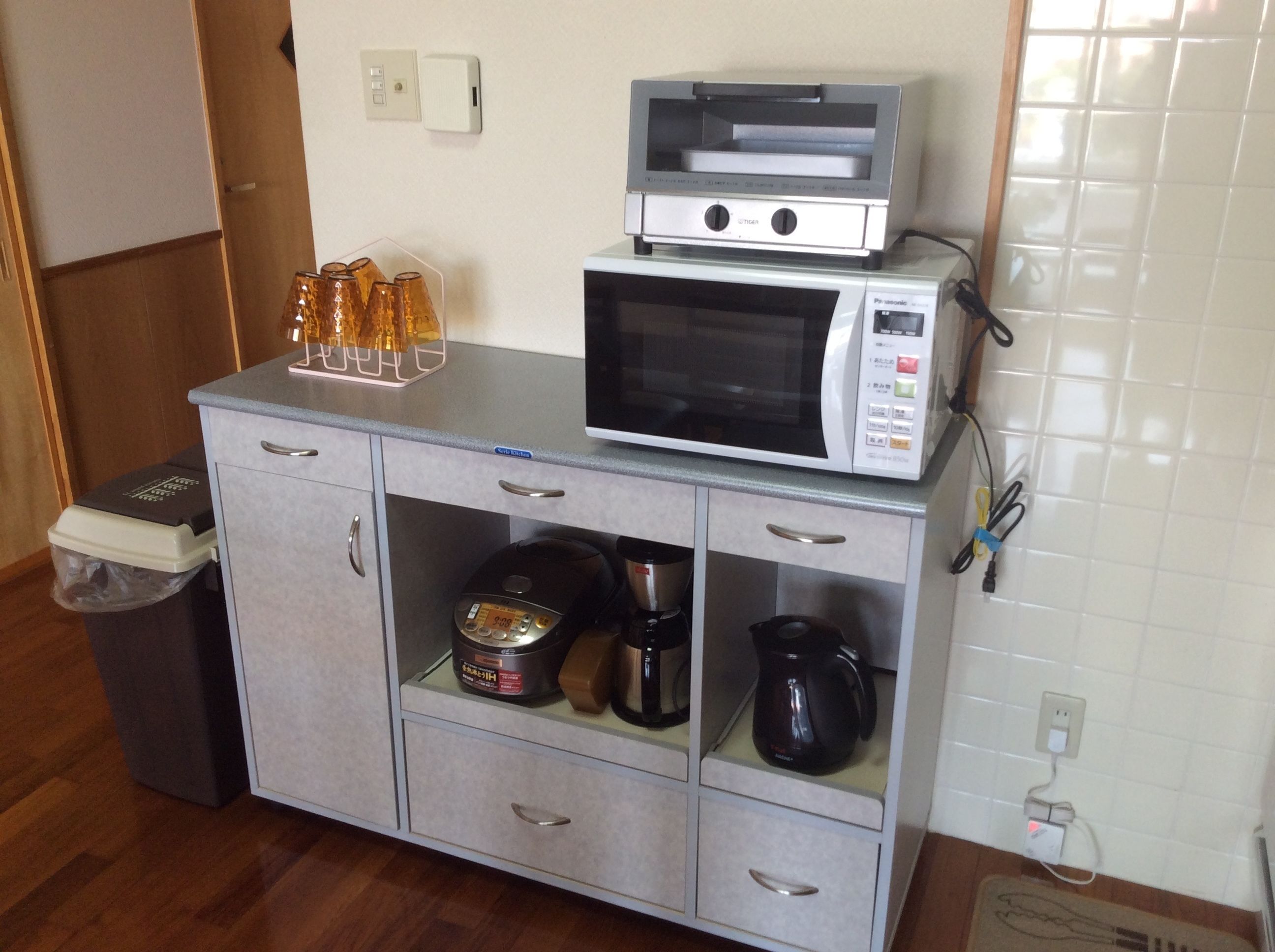 A kitchenette with a microwave, a coffee maker, and a small refrigerator.