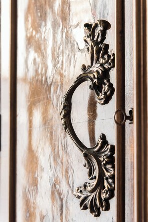 A close-up of an ornate, antique door handle with intricate designs.