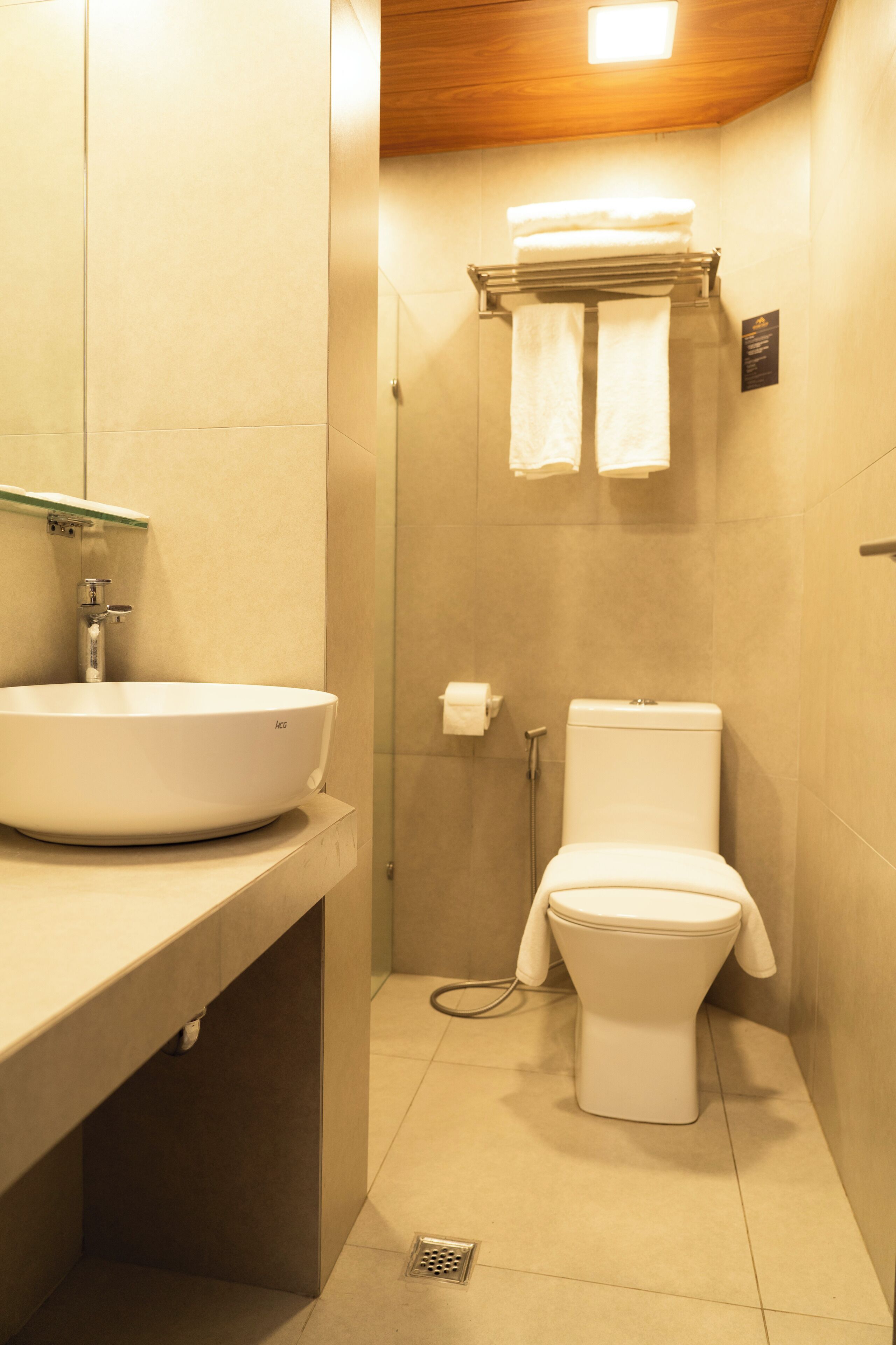 A bathroom with a white sink, toilet, and shower.