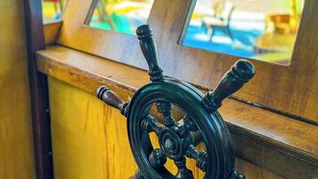 A close-up of a ship's wheel, indicating a nautical theme.