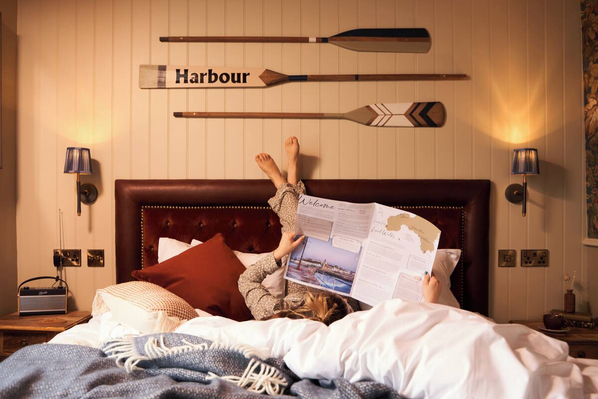 A bed with a map, a radio, and a sign reading "Harbour".