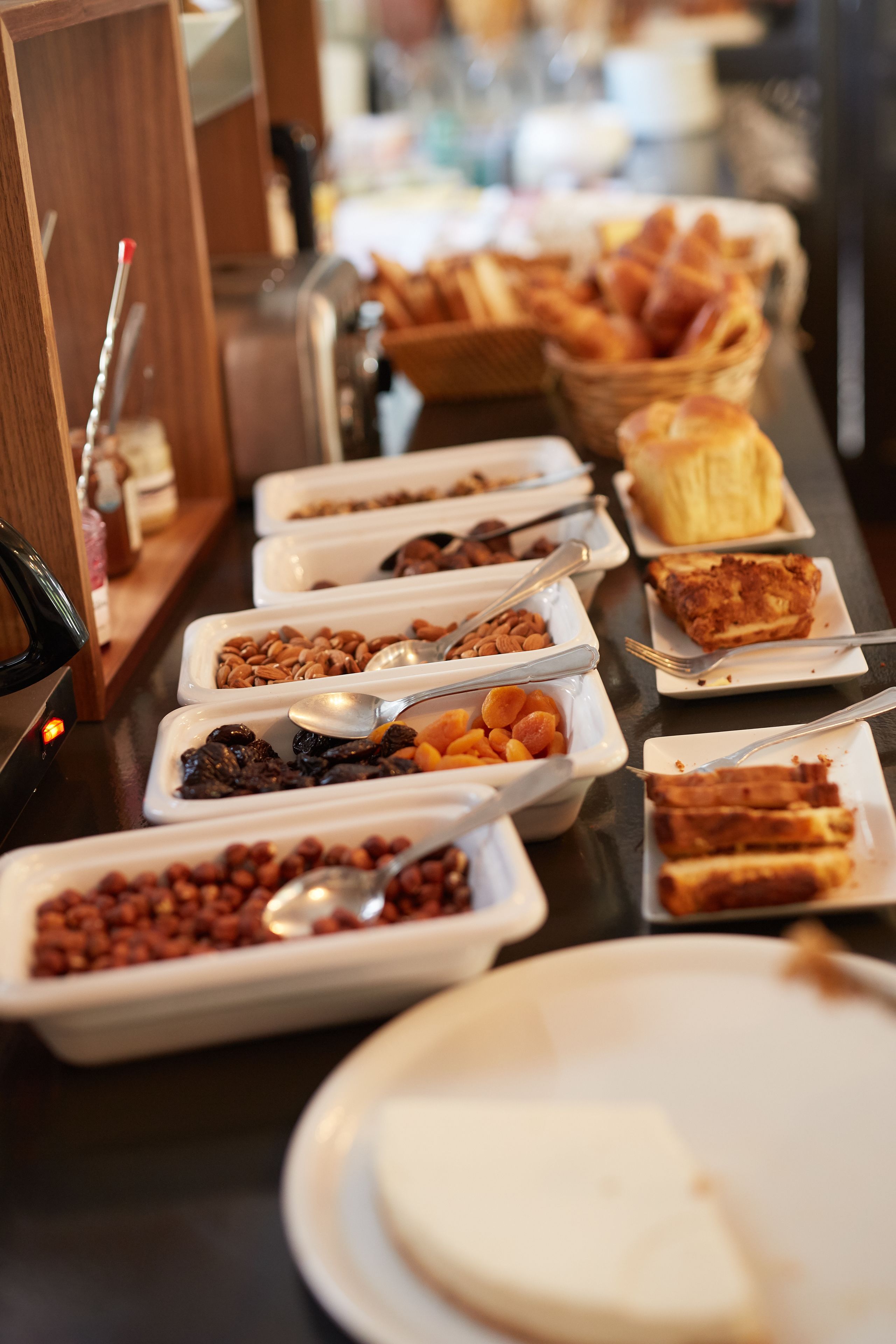 A buffet with various food items and utensils.
