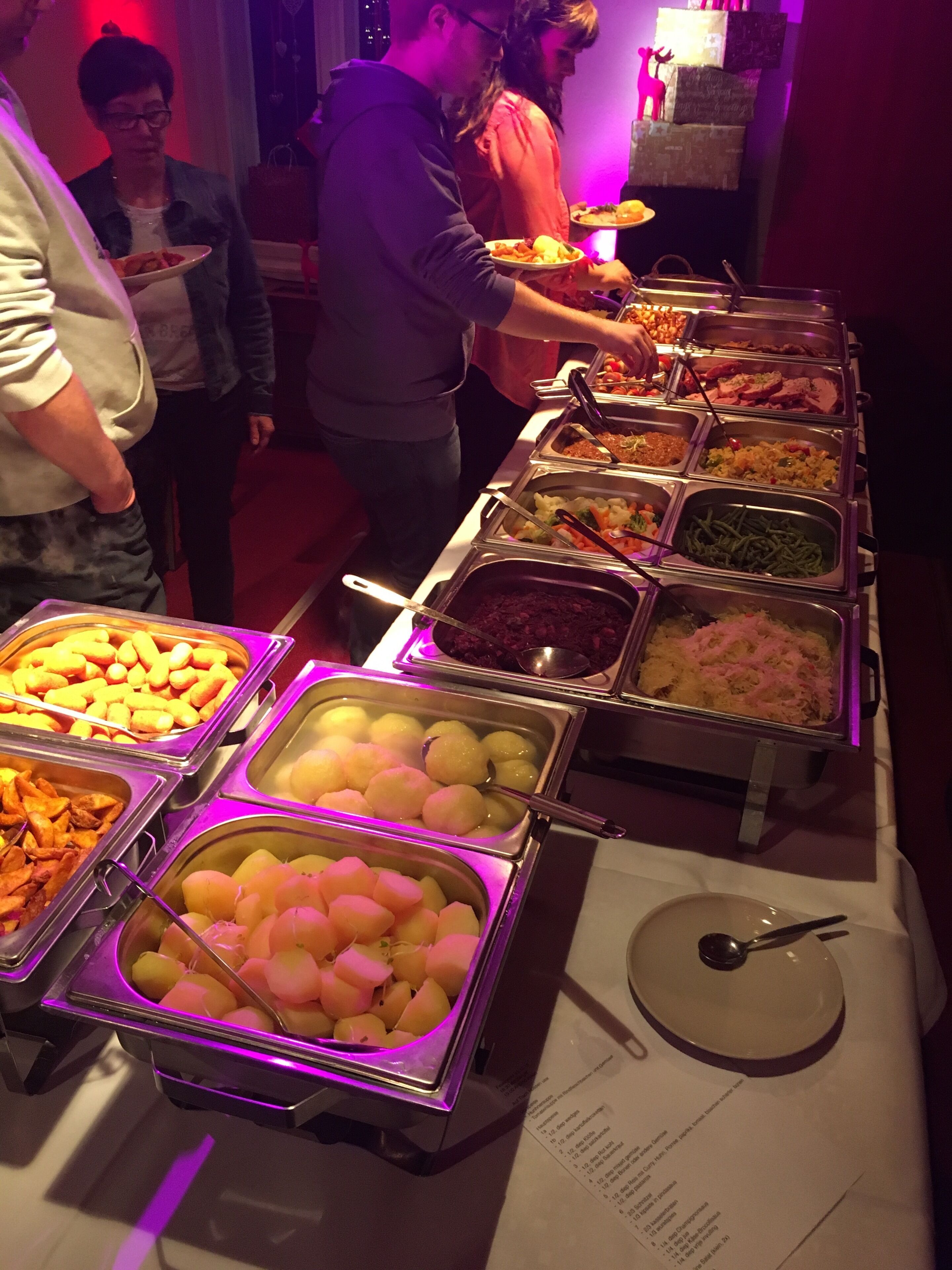 A buffet with various food items in metal containers.