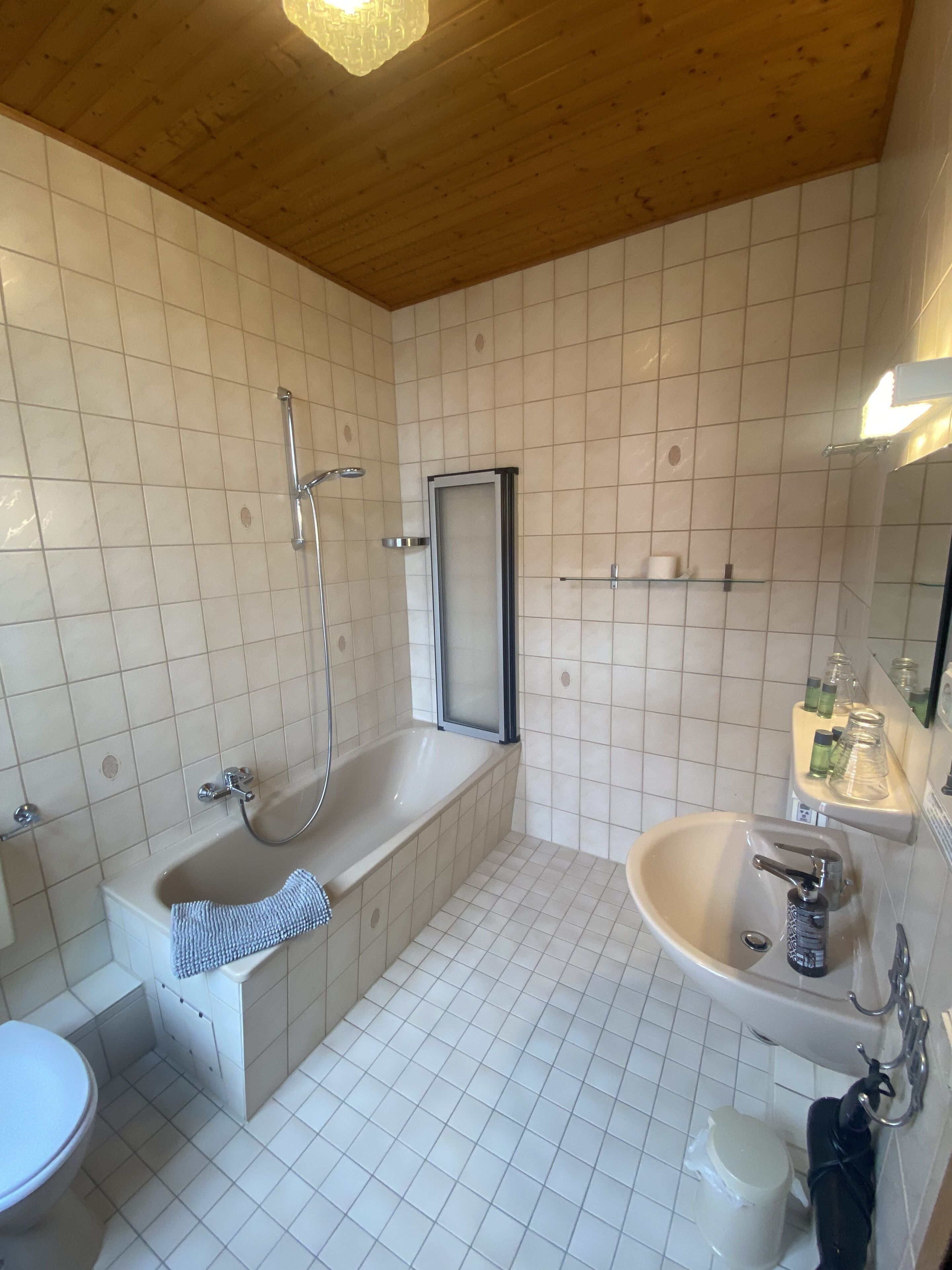 A bathroom with a bathtub, a sink, and a toilet.