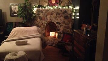 Cozy bedroom with a fireplace, featuring a comfortable bed and a dresser.