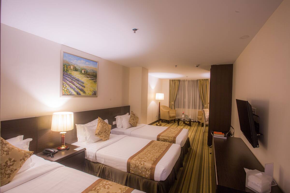 Deluxe Triple Room, 1 Bedroom | Minibar, in-room safe, desk, blackout drapes