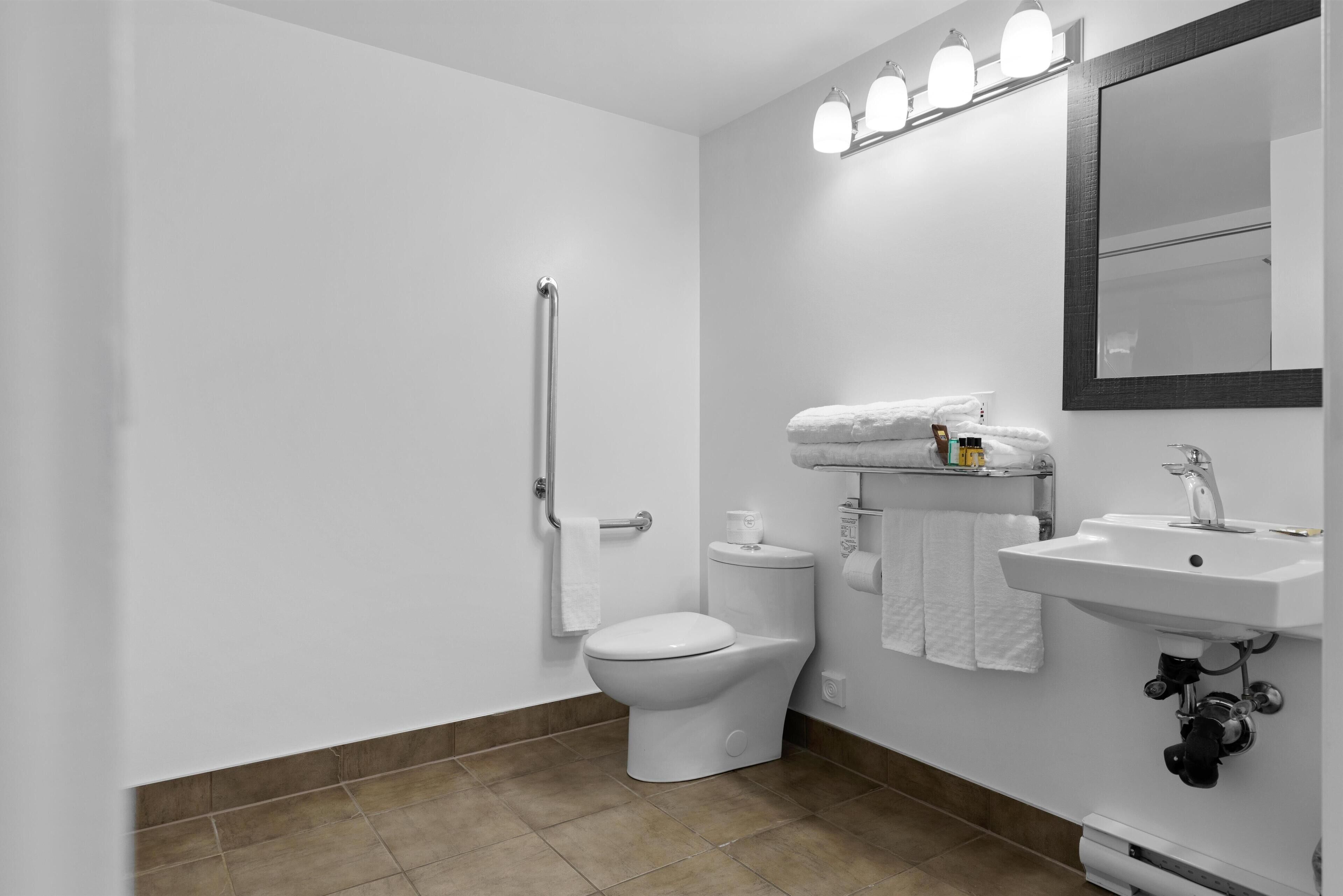 A modern bathroom with a toilet, bidet, and sink.