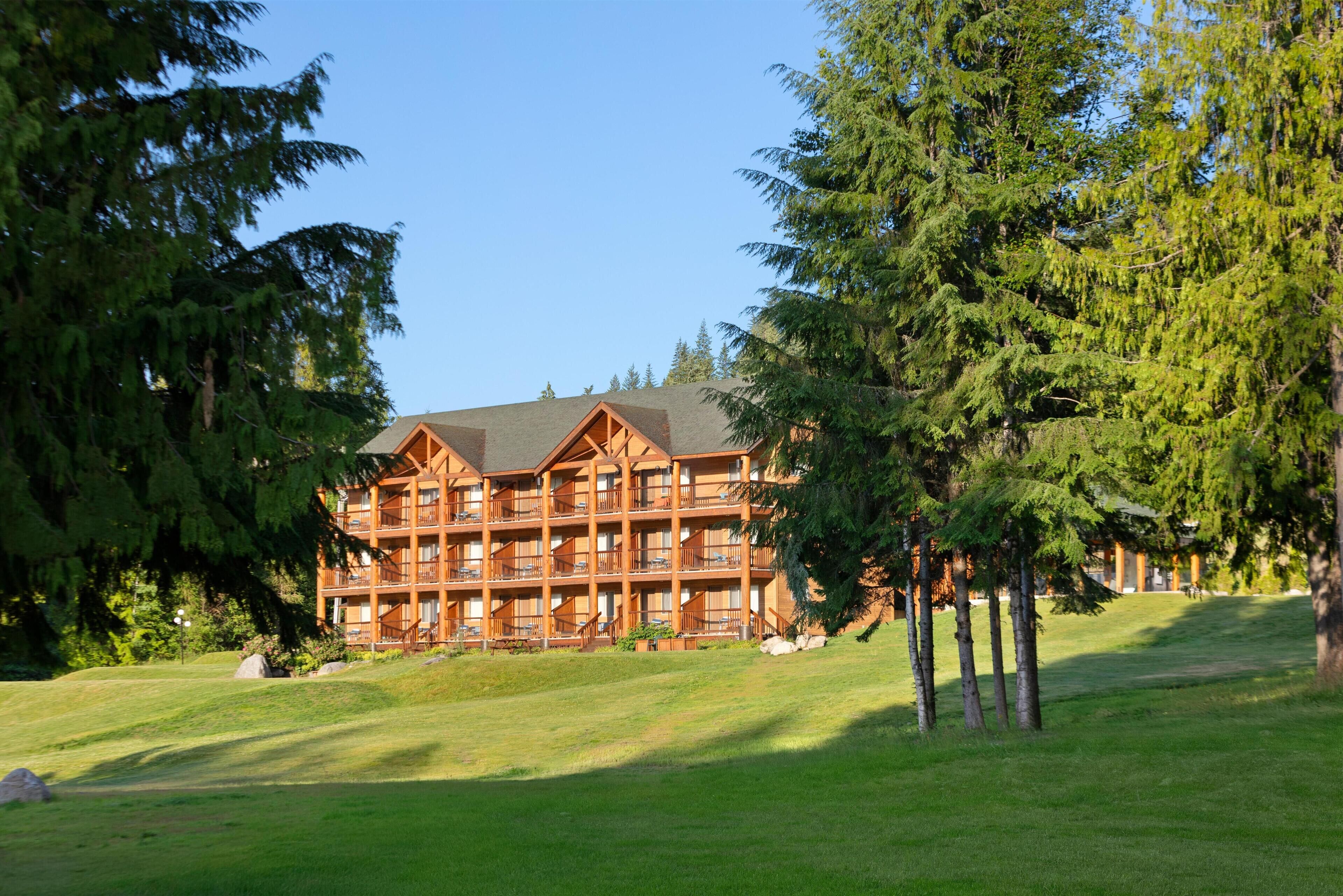 A multi-story lodge with a symmetrical facade, large windows, and a central entrance.