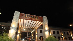 The exterior of a hotel with a prominent sign reading "Linca Hotels".