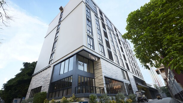 A modern hotel with a prominent 'Vince' sign, large windows, and a clean facade. - Vince Hotel Pratunam (Bangkok)