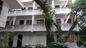 A multi-story building with white walls and balconies. - Pension Natividad (Manila)