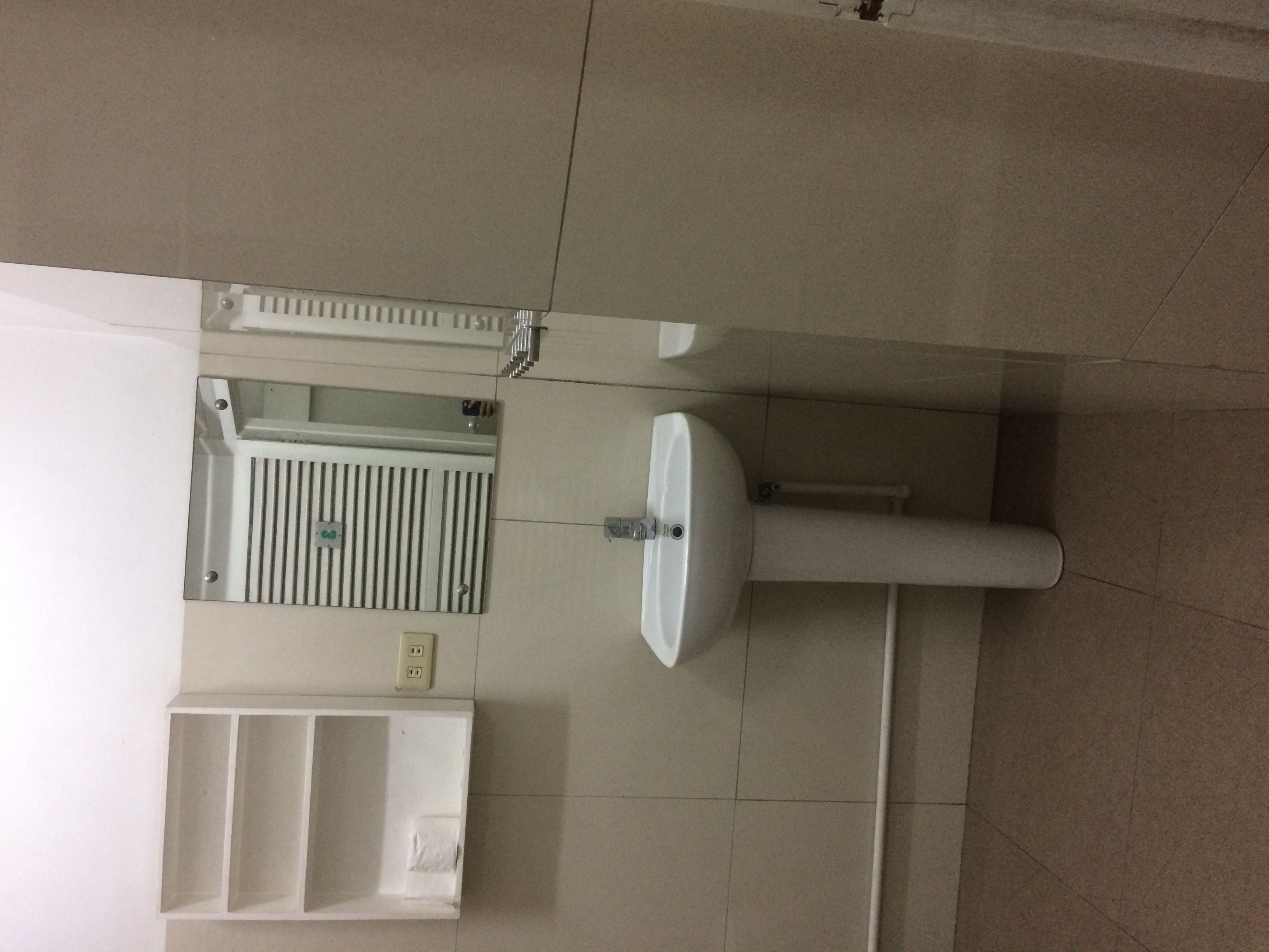 A bathroom with a sink, mirror, and a towel rack.