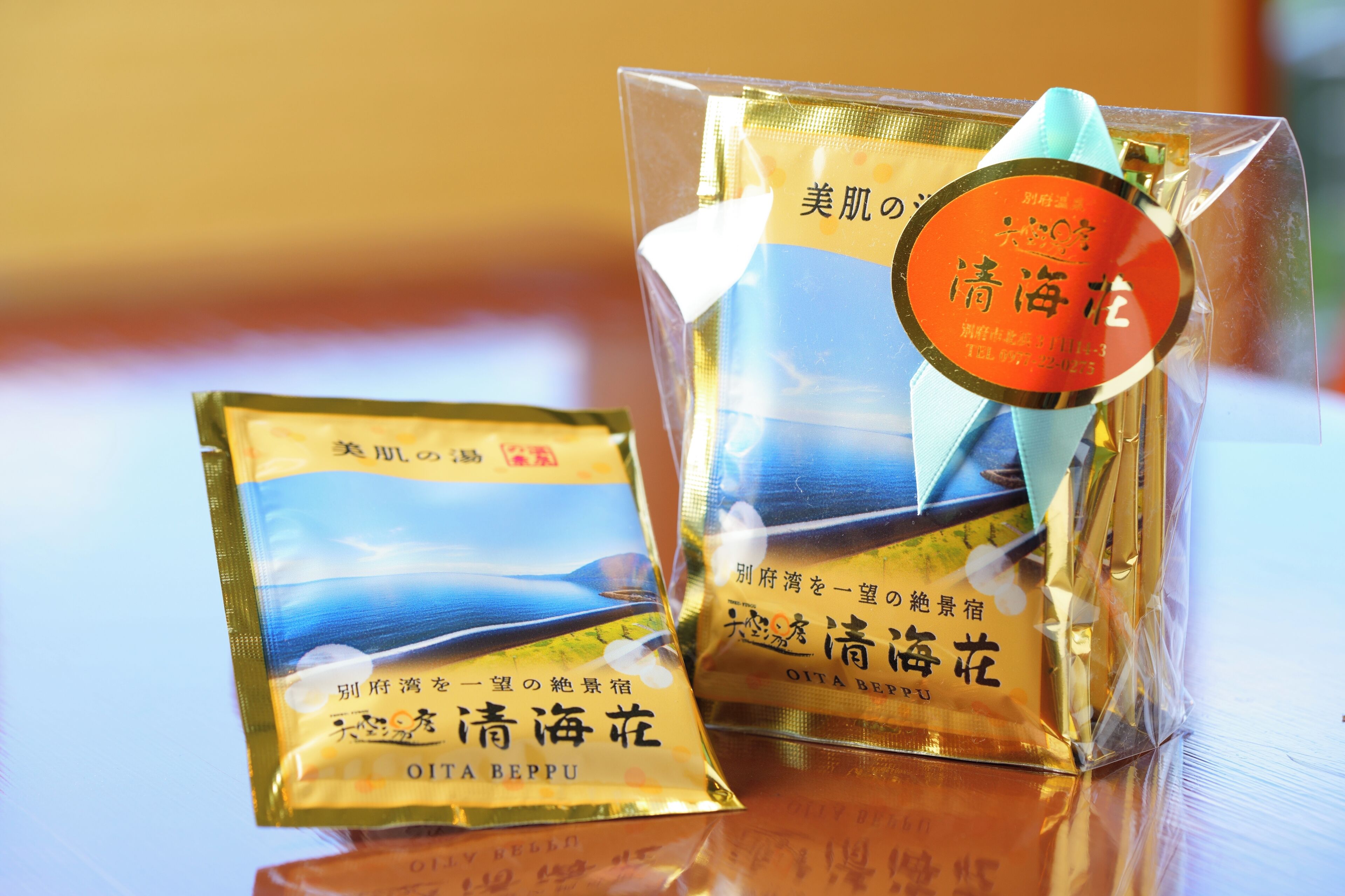 Two packages of Oita Beppu bottled water with a clear label and a blue ribbon.