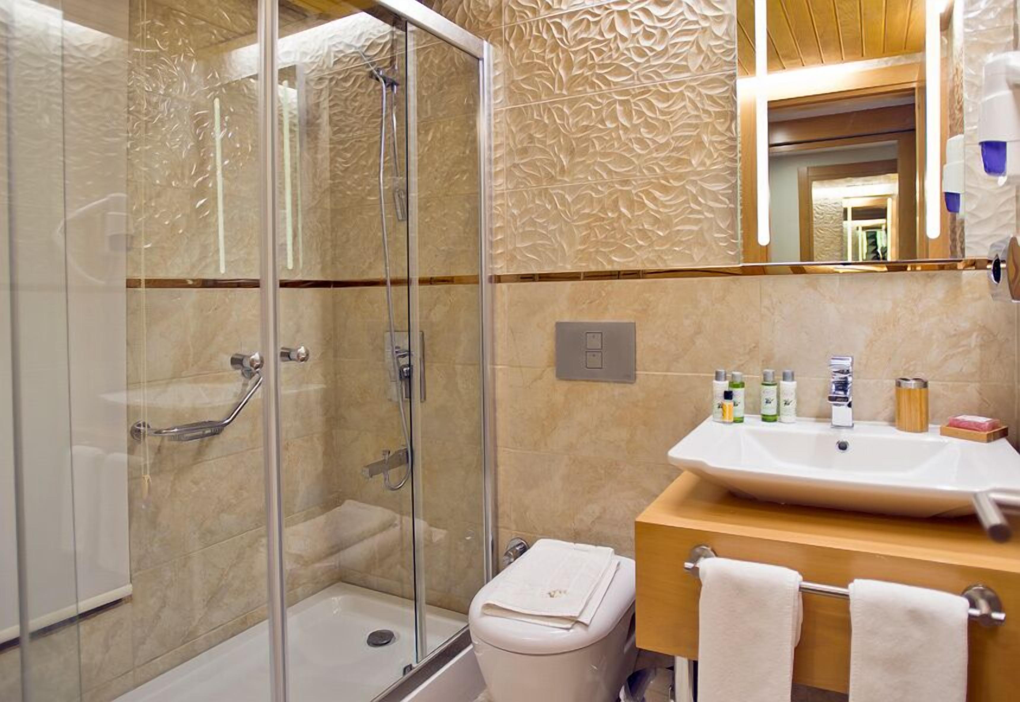 shower, hair dryer, slippers, towels