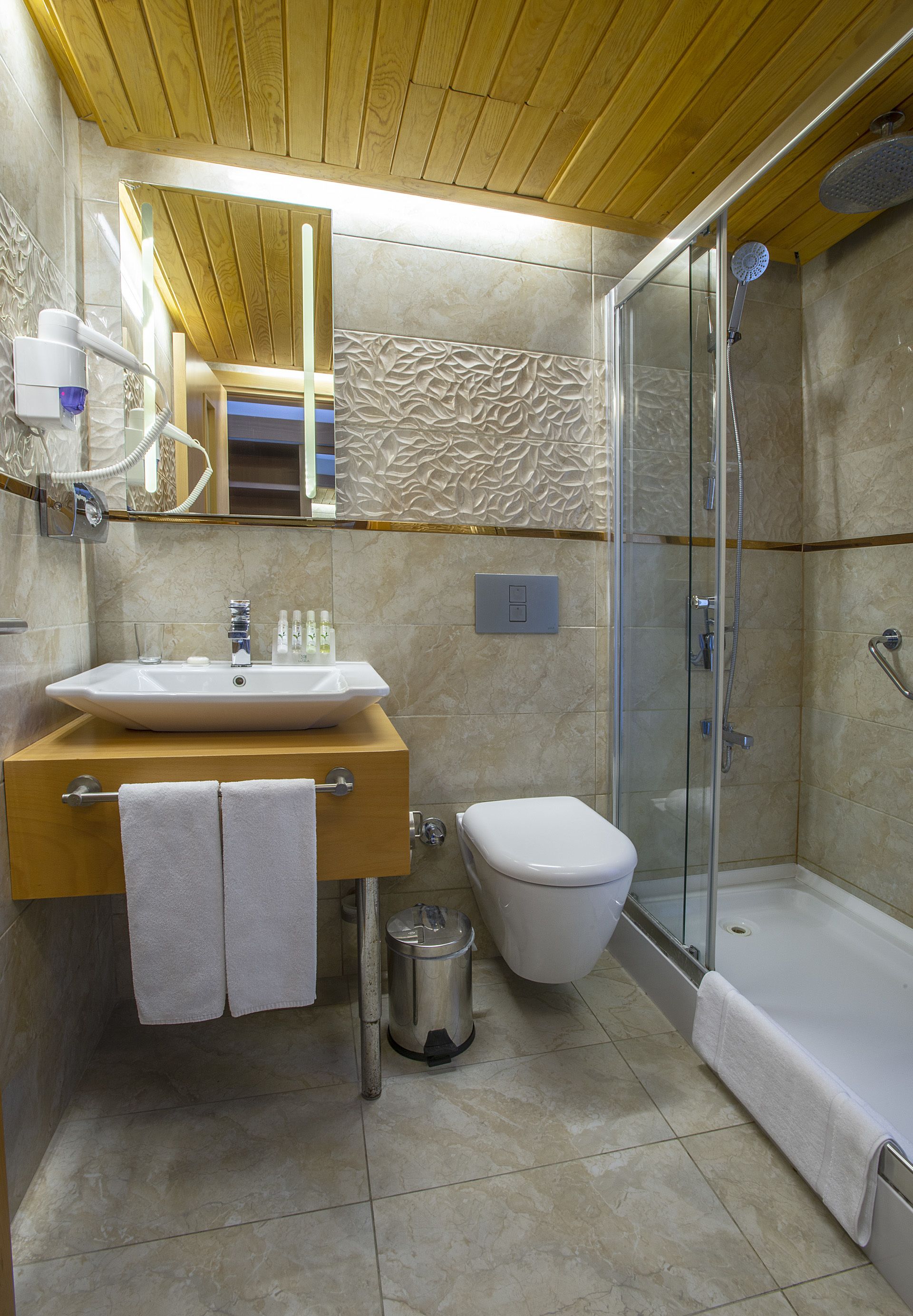 shower, hair dryer, slippers, towels