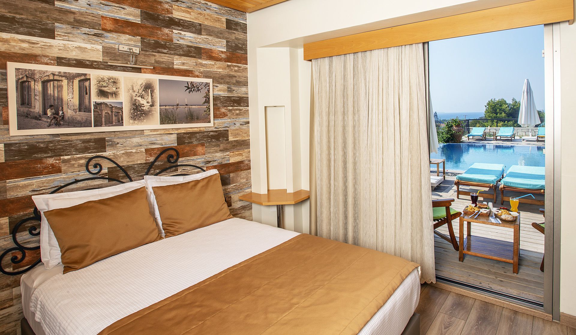 A hotel room with a bed, wooden wall decor, a balcony with a pool view.