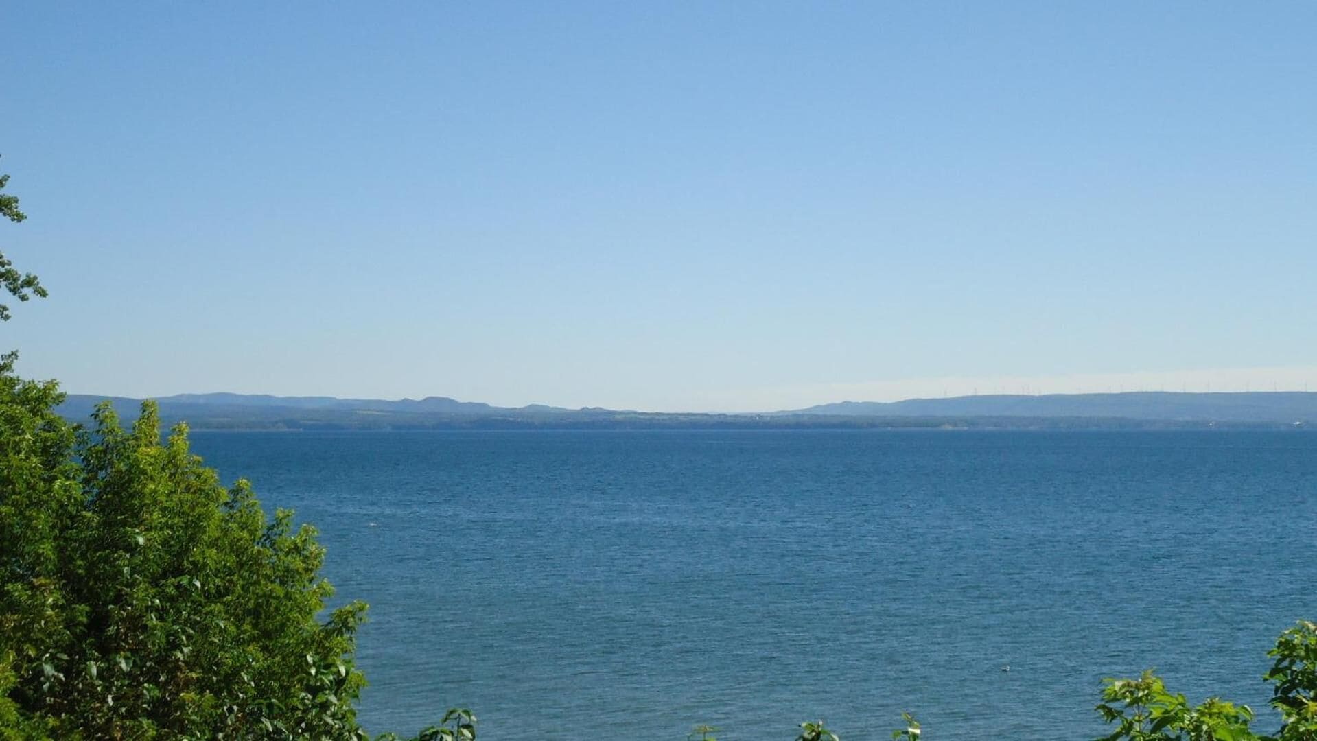 A coastal view with a clear sky and calm sea.