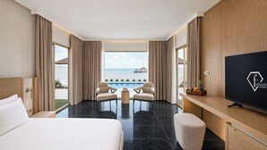 A hotel room with a bed, a TV, a pool table, and a view of the ocean. - FashionTV Luxe Resort - Luxury All Inclusive (Kemer)