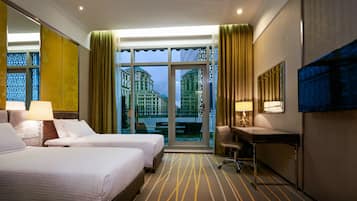 Deluxe Room, Garden View | Minibar, in-room safe, desk, laptop workspace
