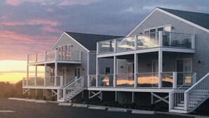 A two-story house with a balcony on the upper floor and a staircase leading to the second floor. - Top Mast Resort (North Truro)