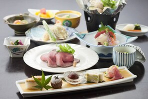 A variety of Japanese dishes on a table, including sashimi and sushi. - Kusatsu Hotel (Kusatsu)