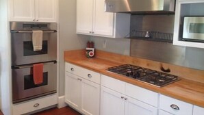Main Street Bungalow | Cocina privada | Cafetera y tetera, refrigerador con congelador y microondas