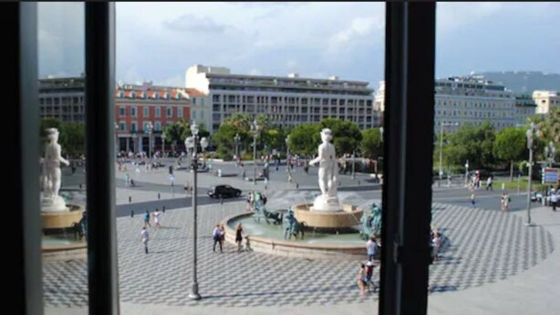 A plaza with statues, a fountain, and buildings in the background. - Les Suites Massena (Nice)