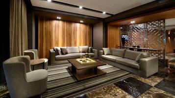 A modern living room with a sectional sofa, armchairs, and a coffee table.