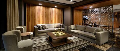 A modern living room with a sectional sofa, armchairs, and a coffee table.