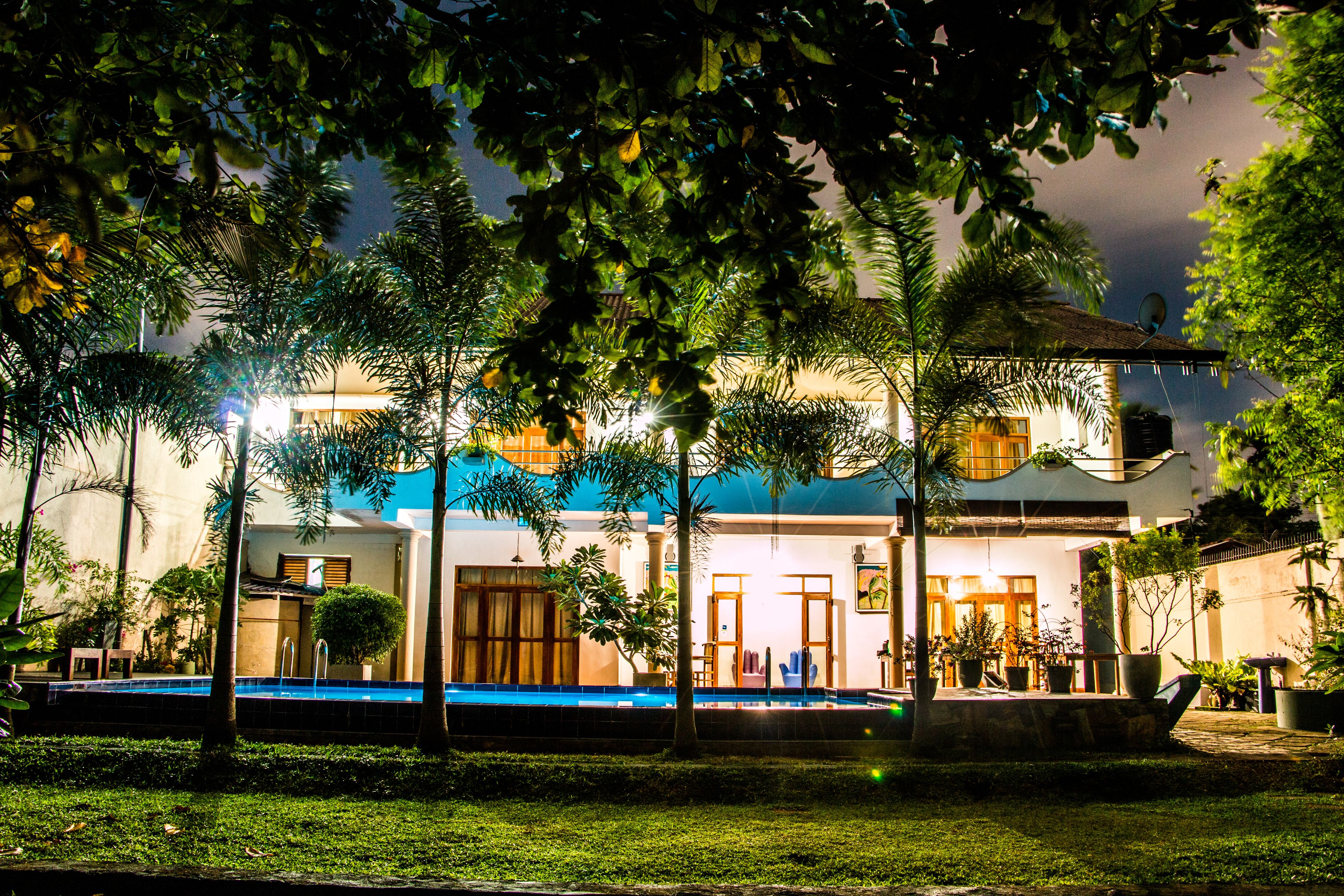 Outdoor pool, a waterfall pool, pool umbrellas, sun loungers