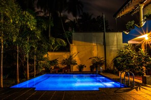 Outdoor pool, a waterfall pool, pool umbrellas, pool loungers