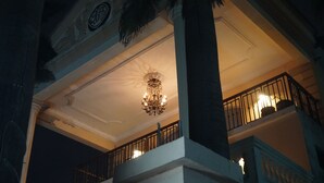 A grand building with a balcony, ornate ceiling, and a chandelier. - Accra Royal Castle Apartments & Suites (Kwabenya)