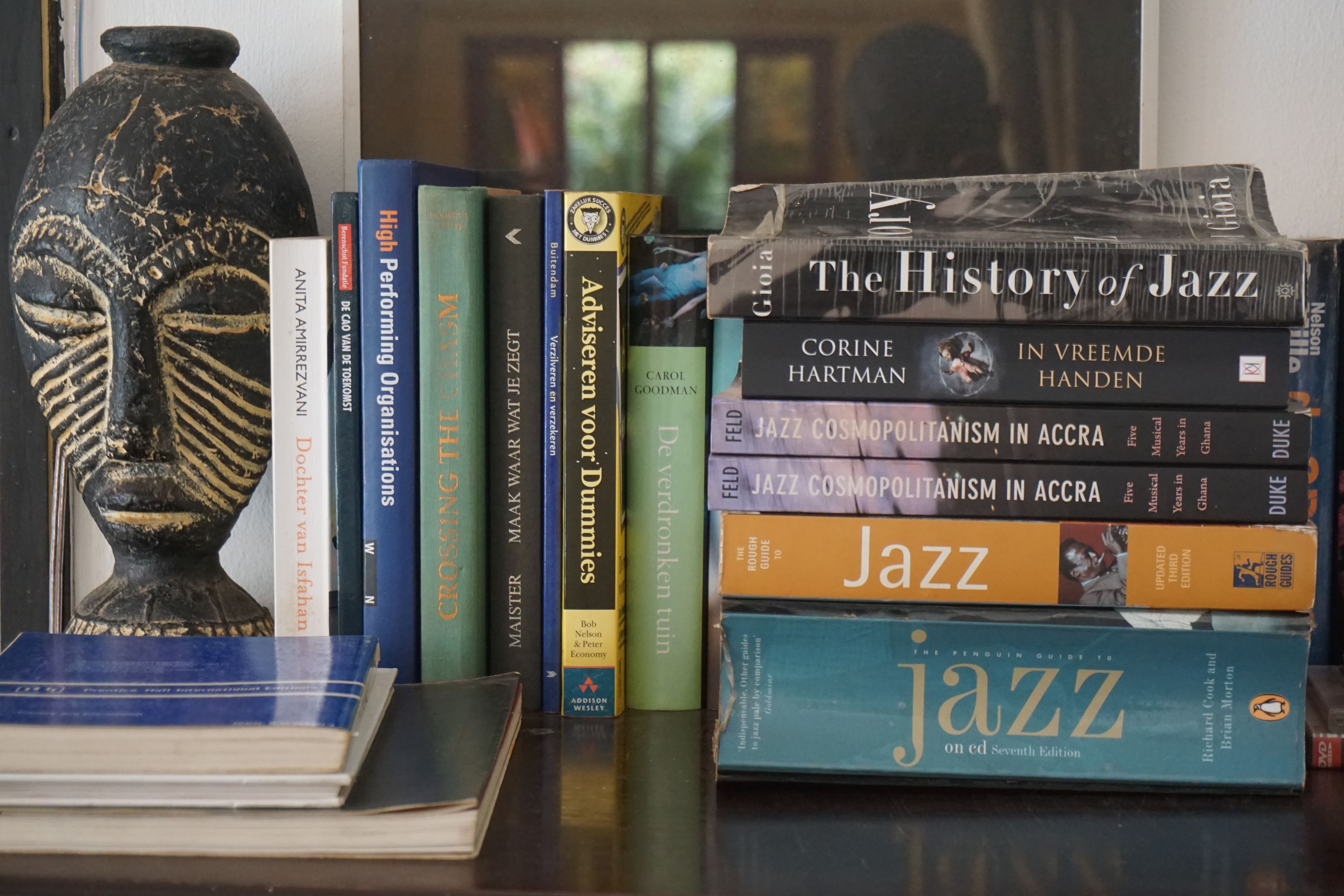 A stack of books on a table, including titles related to jazz and performance.