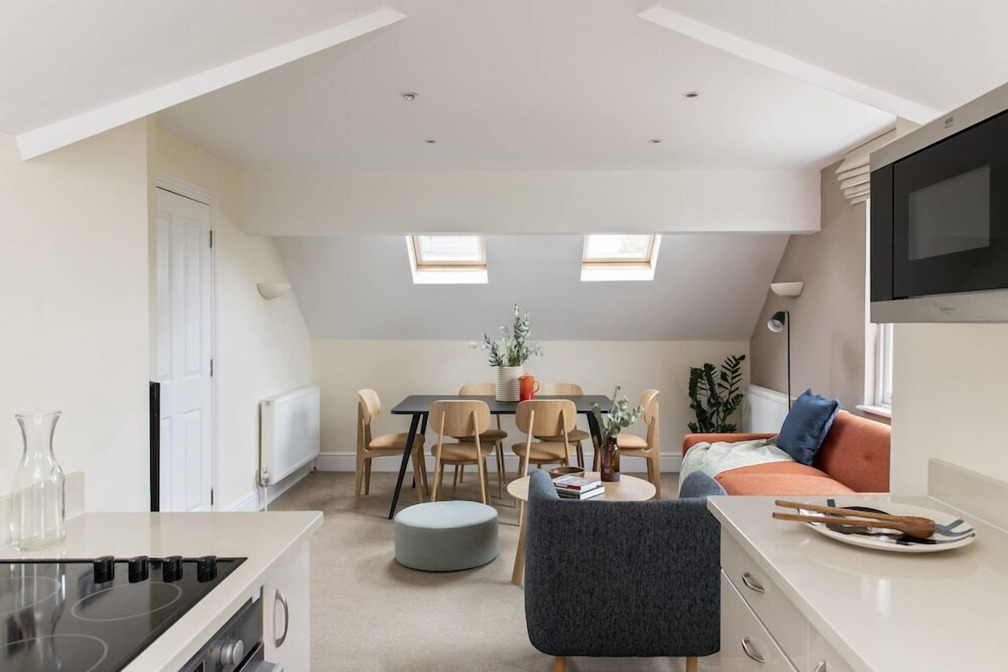 A modern apartment with a kitchen, dining area, and living space.
